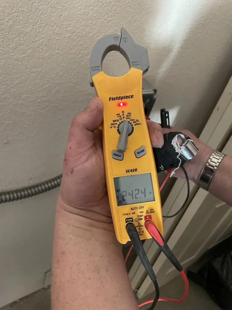 Voltage testing with clamp meter during Recessed Lighting Installation in Tecumseh